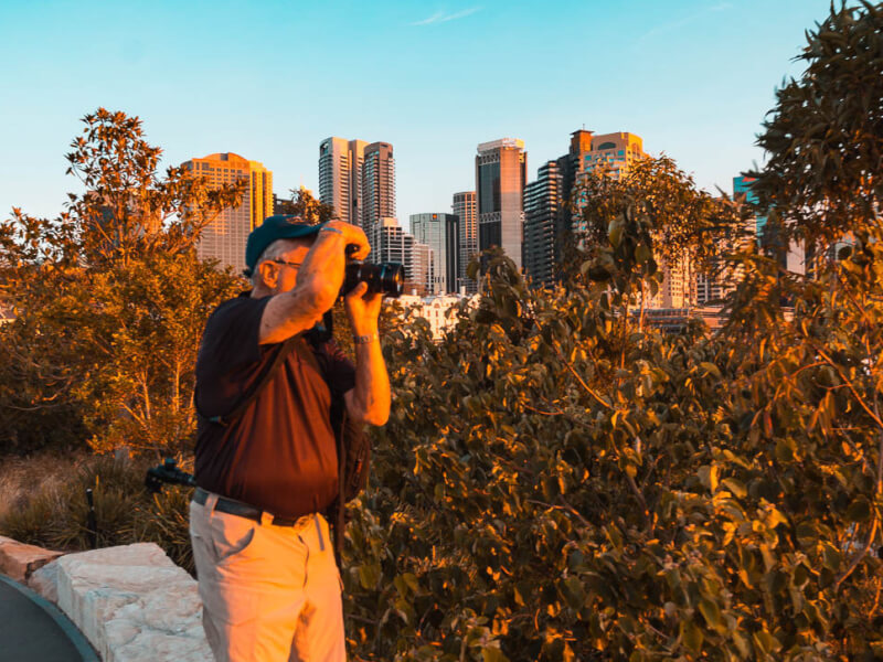 man taking photos at sunset
